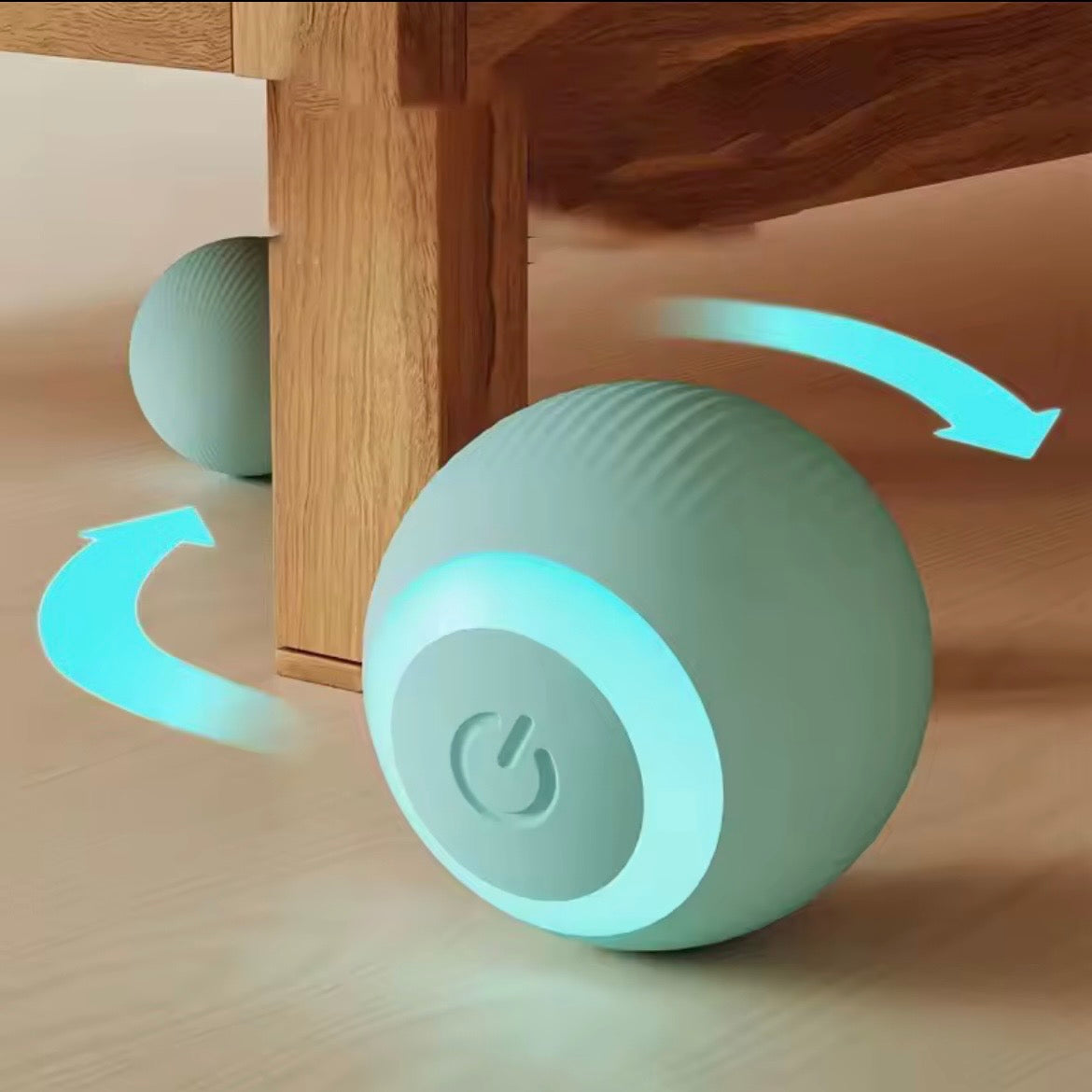 Green automatic rolling ball toy bouncing off furniture leg with motion arrows showing self-righting ability — smart interactive pet ball