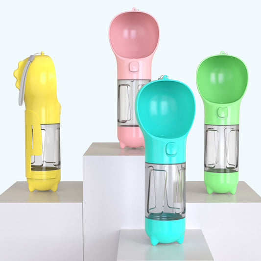 Multi-purpose dog walk bottle in four colours — yellow, pink, teal and green — displayed on white plinths — portable water food and poop shovel bottle for dogs