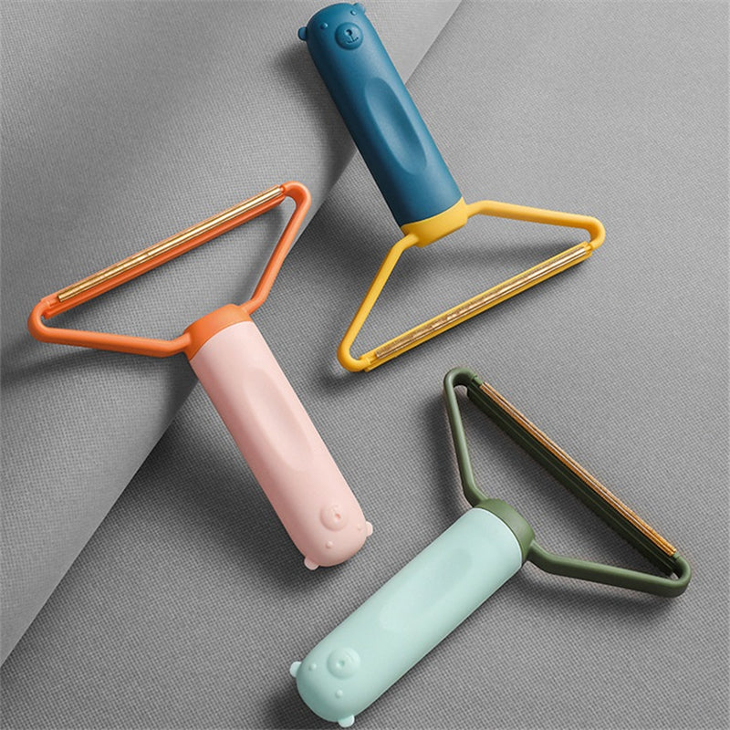 Three colorful lint rollers on a gray background