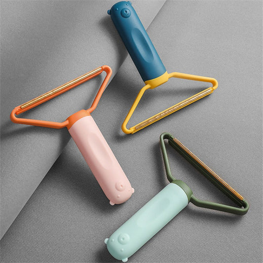 Three colorful lint rollers on a gray background