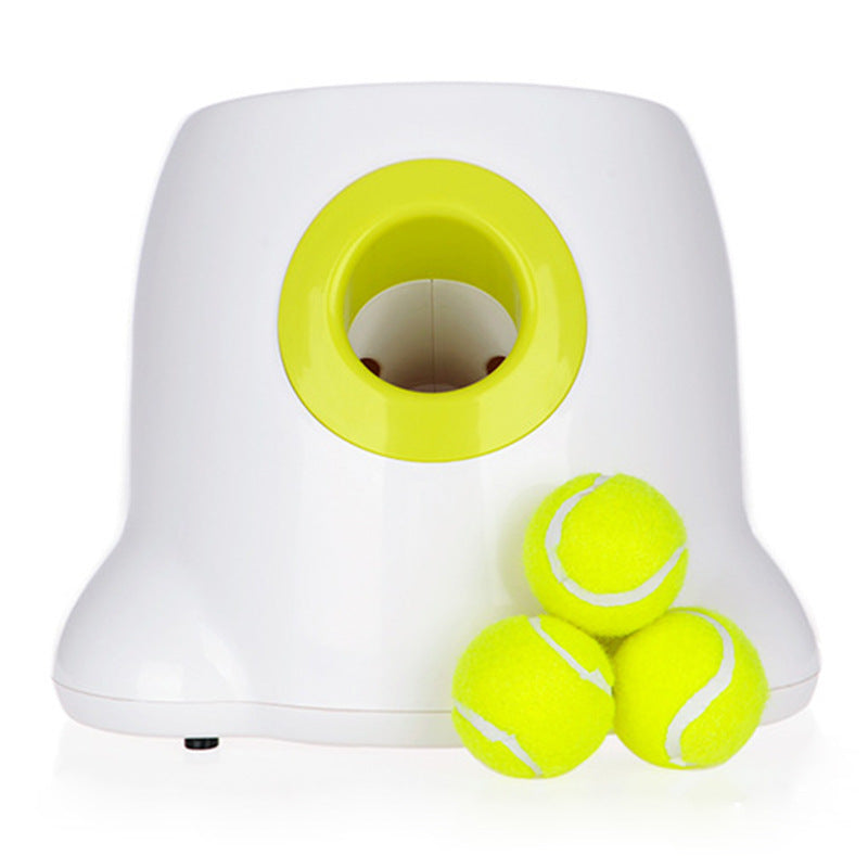 White and yellow tennis ball dispenser with three tennis balls on a white background