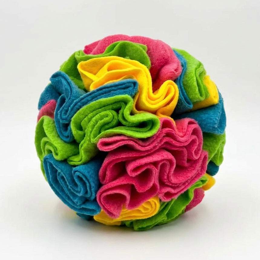Dog snuffle ball in bright multicolour fleece — pink, blue, green and yellow — on white background — washable dog enrichment treat ball