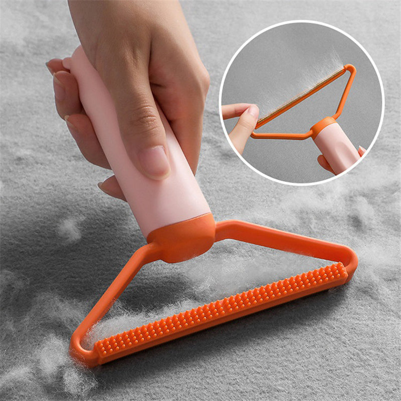 Hand using orange pet hair remover on grey fabric with close-up inset showing wire scraper head — reusable pet hair remover for sofas and carpets