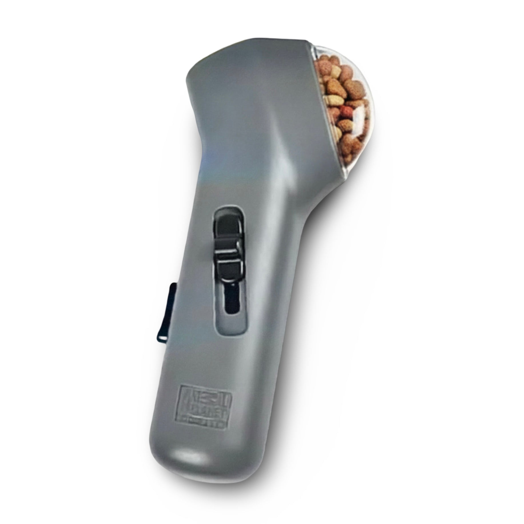 Grey pet treat launcher with transparent treat chamber loaded with dog kibble on white background — handheld dog treat dispenser