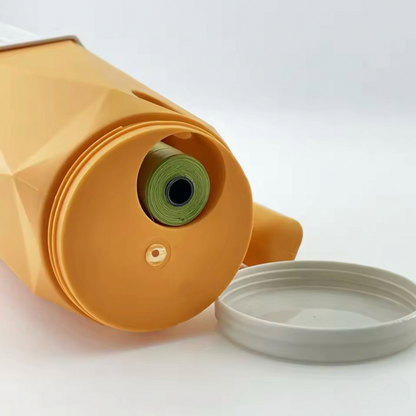 Close-up of orange cat litter scoop showing built-in poo bag roll compartment with lid removed — litter scoop with integrated waste bag dispenser