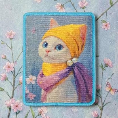 Cat scratcher wall mat with illustrated portrait cat in yellow headscarf and purple cape — decorative sisal cat scratching pad