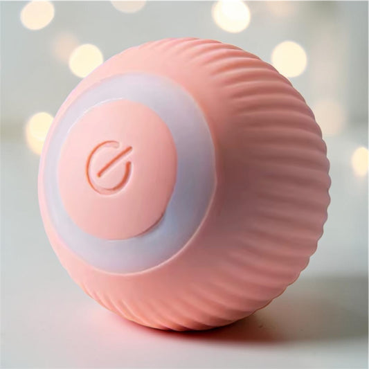 Pink ribbed automatic rolling ball toy with glowing ring on bokeh light background — interactive smart pet ball toy